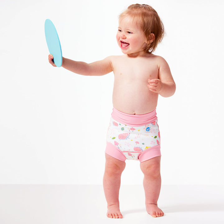 Baby wearing a Pastel colour swim diaper in forest print