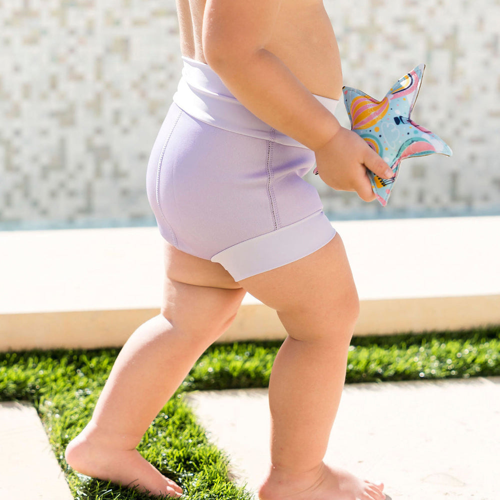 Baby wearing lilac colour swim nappy