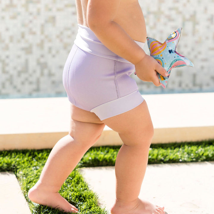 Baby wearing lilac colour swim nappy