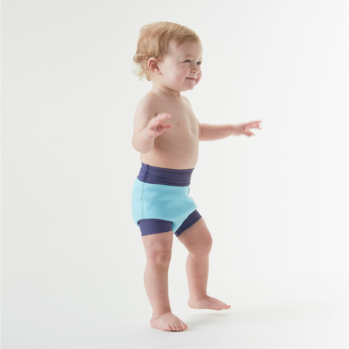 Baby wearing a blue swim nappy
