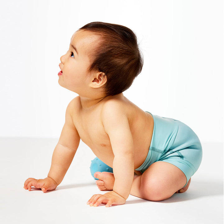 Baby wearing a swim diaper in pistachio colour
