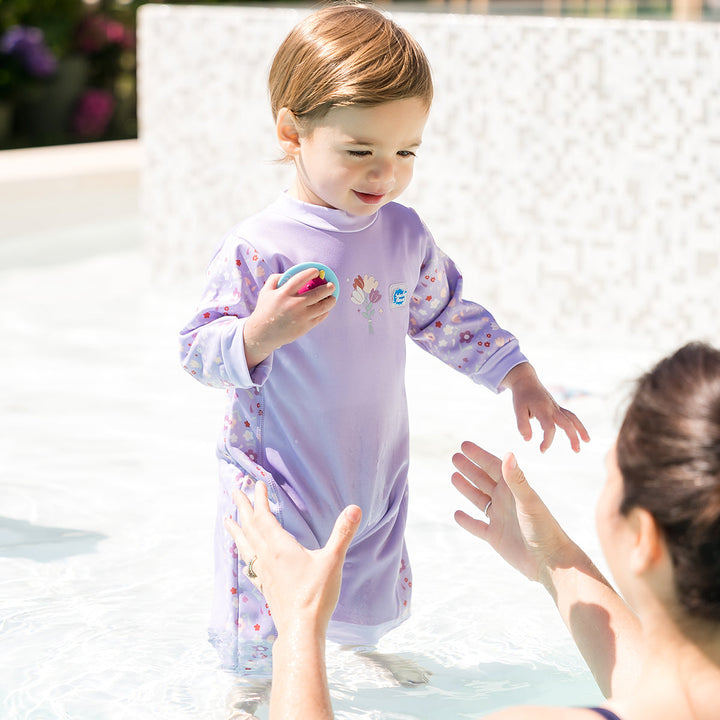 Baby wearing a warm baby westsuit in floral print