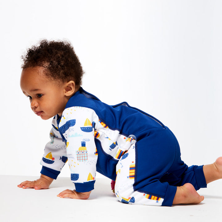 Baby wearing a Warm baby wetsuit with boats